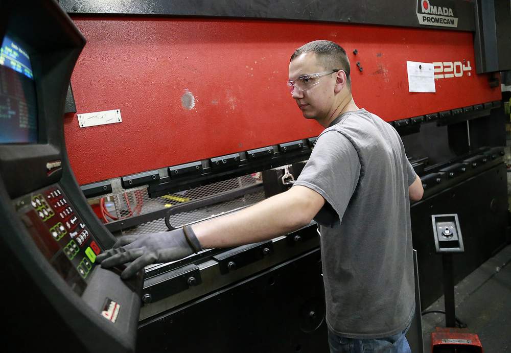 Kirby McGillivray,  an employee at Valco Industries in Springfield,  operates a break press Monday. A recent PEW research study showed Clark County lost a share of its middle class,  likely as manufacturing jobs were cut in half and were replaced by jobs that paid less. Bill Lackey\/Staff
