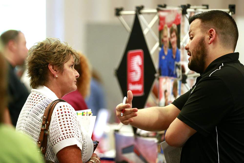 Dea Mehaly talks to Speedway's Kyle Brown about employment opportunities Tuesday at the Chamber of Greater Springfield and OhioMeansJobs Clark County job fair. Bill Lackey\/Staff